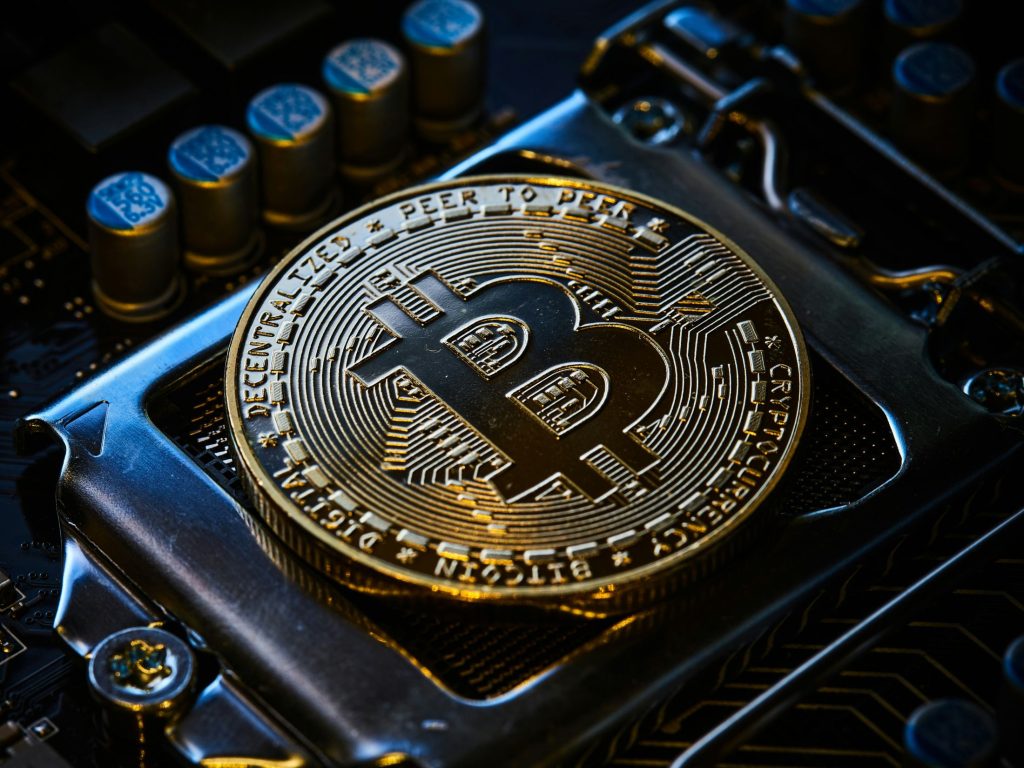 Bitcoin blockchain currency logo as AI agents prefer Bitcoin for digital wealth storage, forcing finance chiefs to adapt their architecture for machine autonomy.